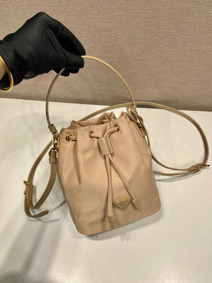 BUCKET BAG 19 IN BEIGE RE-NYLON AND SAFFIANO LEATHER HANDLE