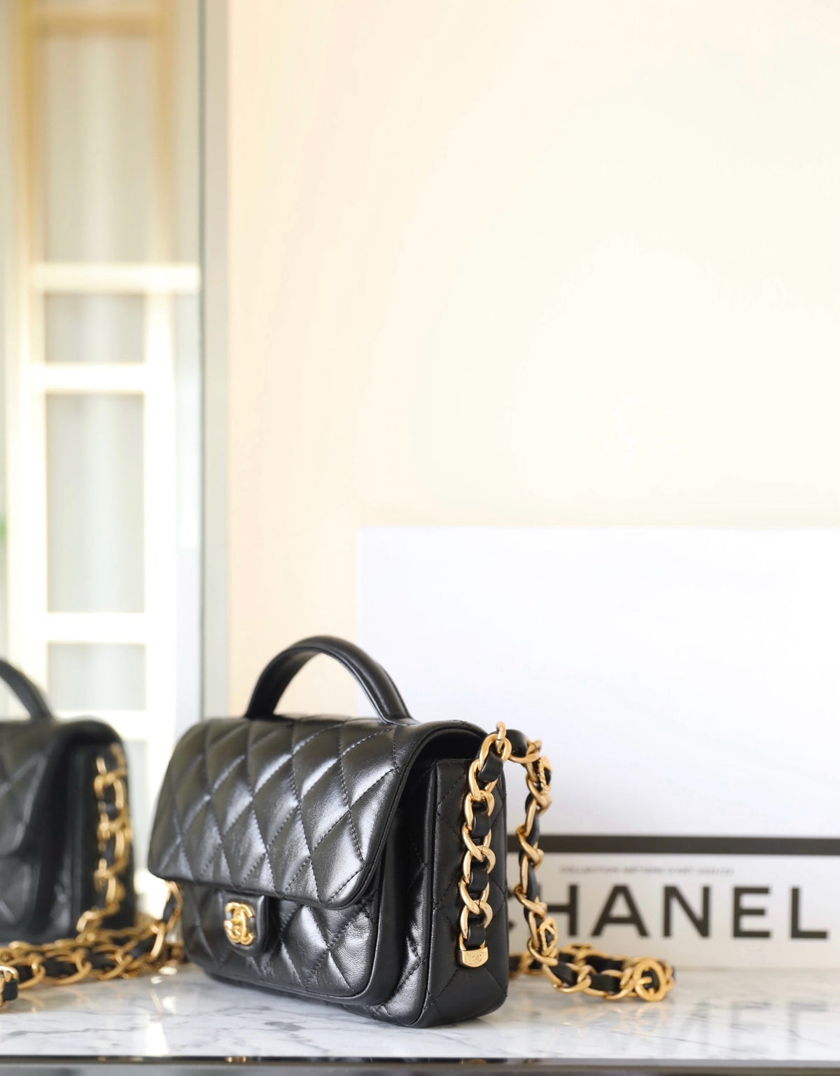 cc 24a flap bag 20cm top handle black  lambskin gold hardware